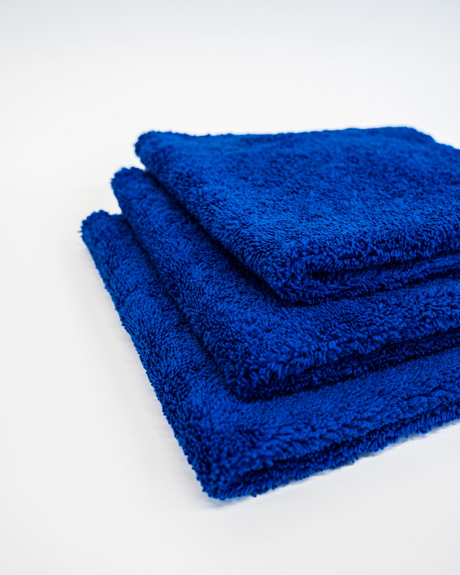 Three blue FibreKing Duplex Edgeless Cloths—3 pack—are neatly stacked on a white surface, highlighting their premium microfibre quality for gentle, precise cleaning.
