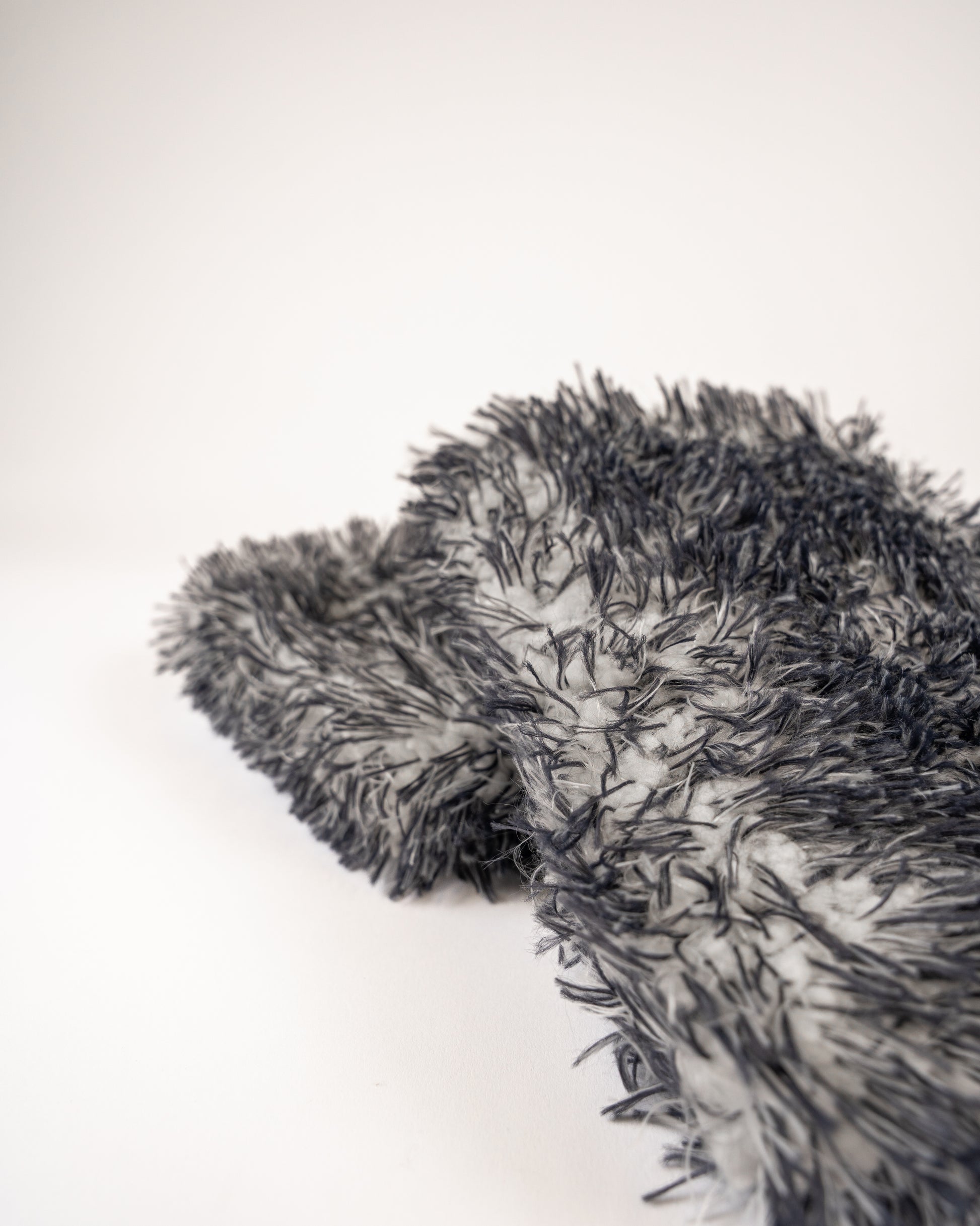 A close-up of the FibreKing Gold Label Korean Microfibre Wash Mitt in grey, showcasing its premium shaggy texture against a plain white background.