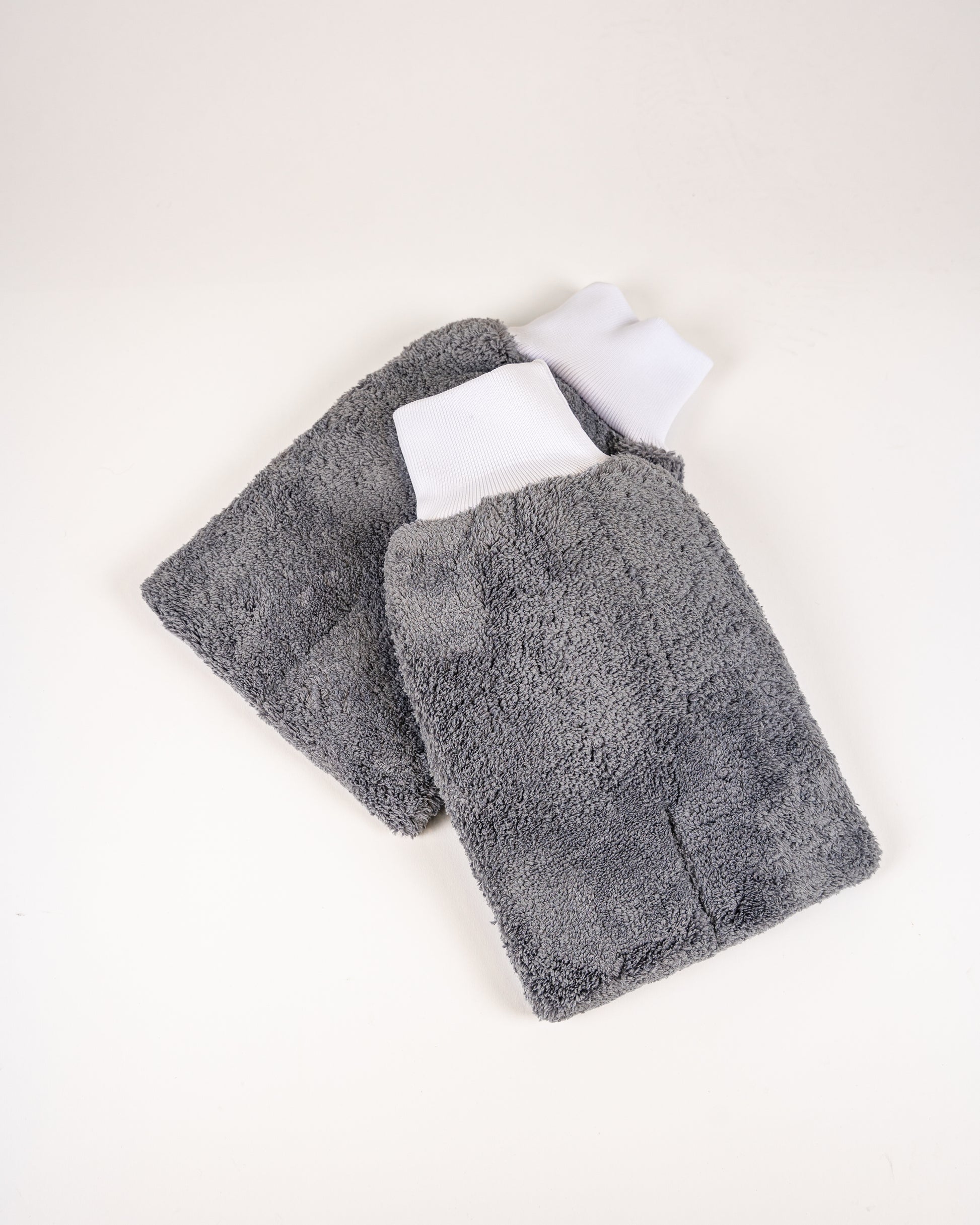 The FibreKing PS Korean Microfibre Mitts—gray, rectangular, and ultra-soft with white elastic cuffs—are ideal for scratch-free car washes.