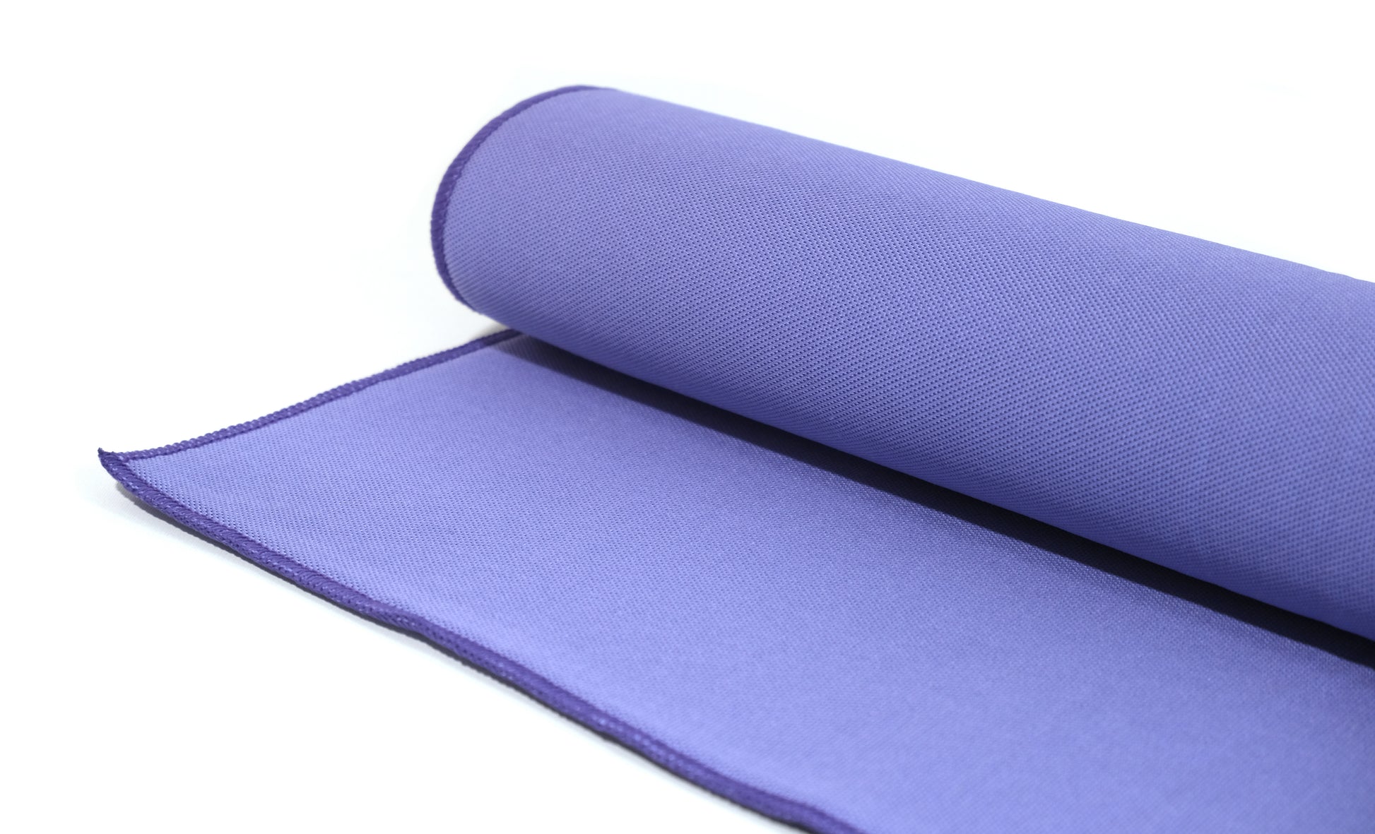 A close-up of a rolled-up purple yoga mat on a white background, shown with FibreKing Gold Label Korean Glass Cloths - 3 Pack for a streak-free finish.