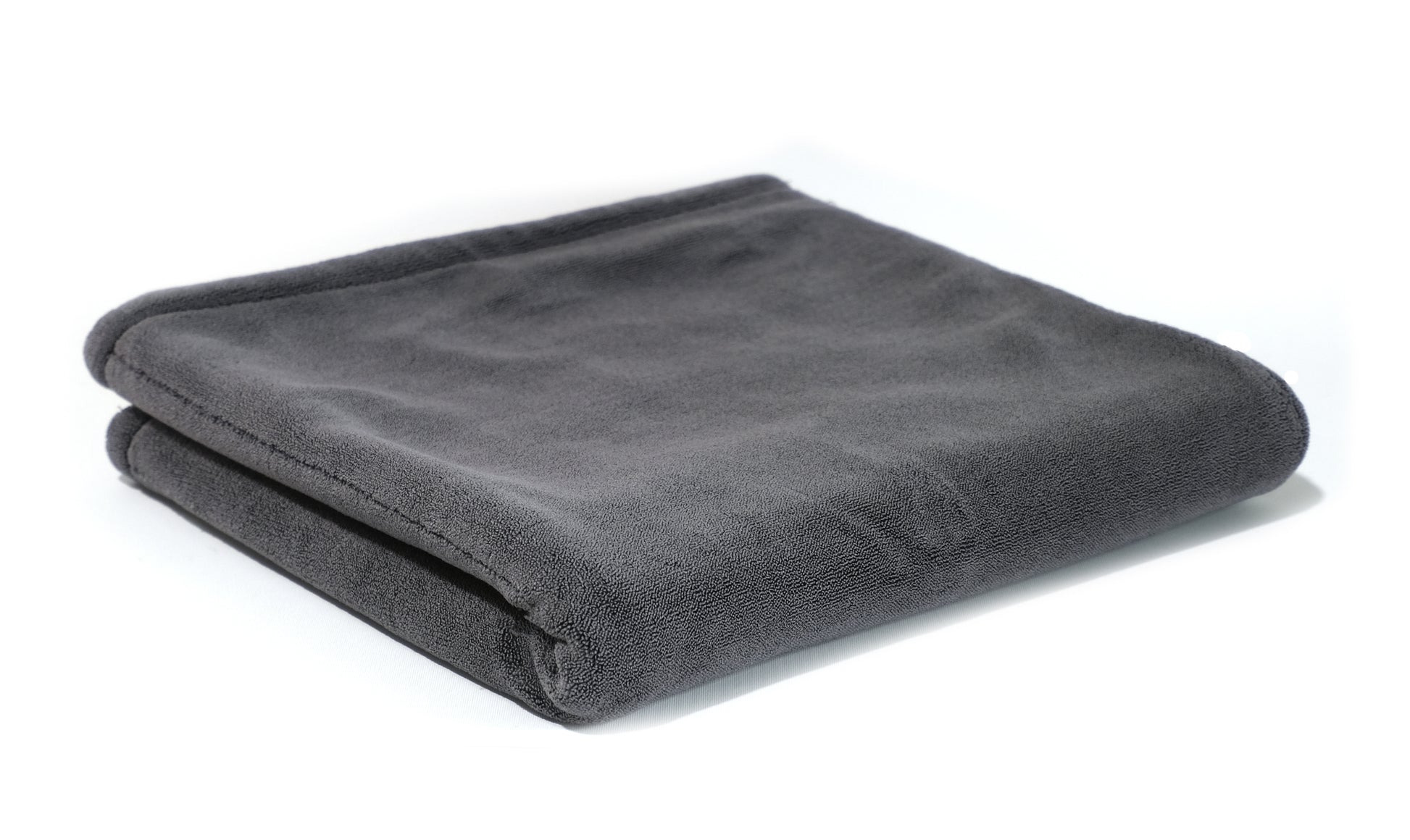 The FibreKing Gold Label 900 GSM Korean Drying Towel, a dark gray microfiber blend inspired by Korean design, is neatly folded and displayed on a white background.
