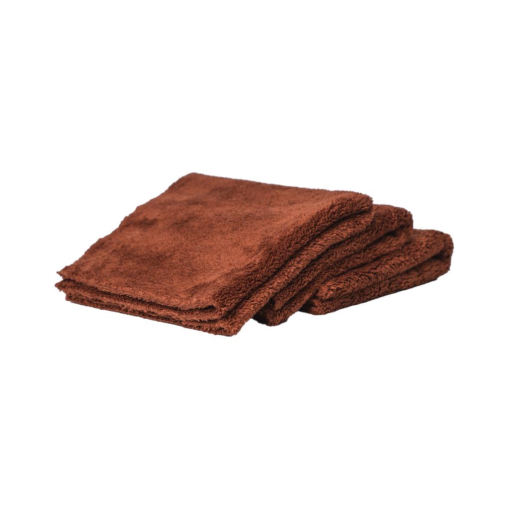 A stack of three folded brown FibreKing Ultimate Detailer Cloths made from coral fleece microfibre, offering a lint-free finish, on a white background.