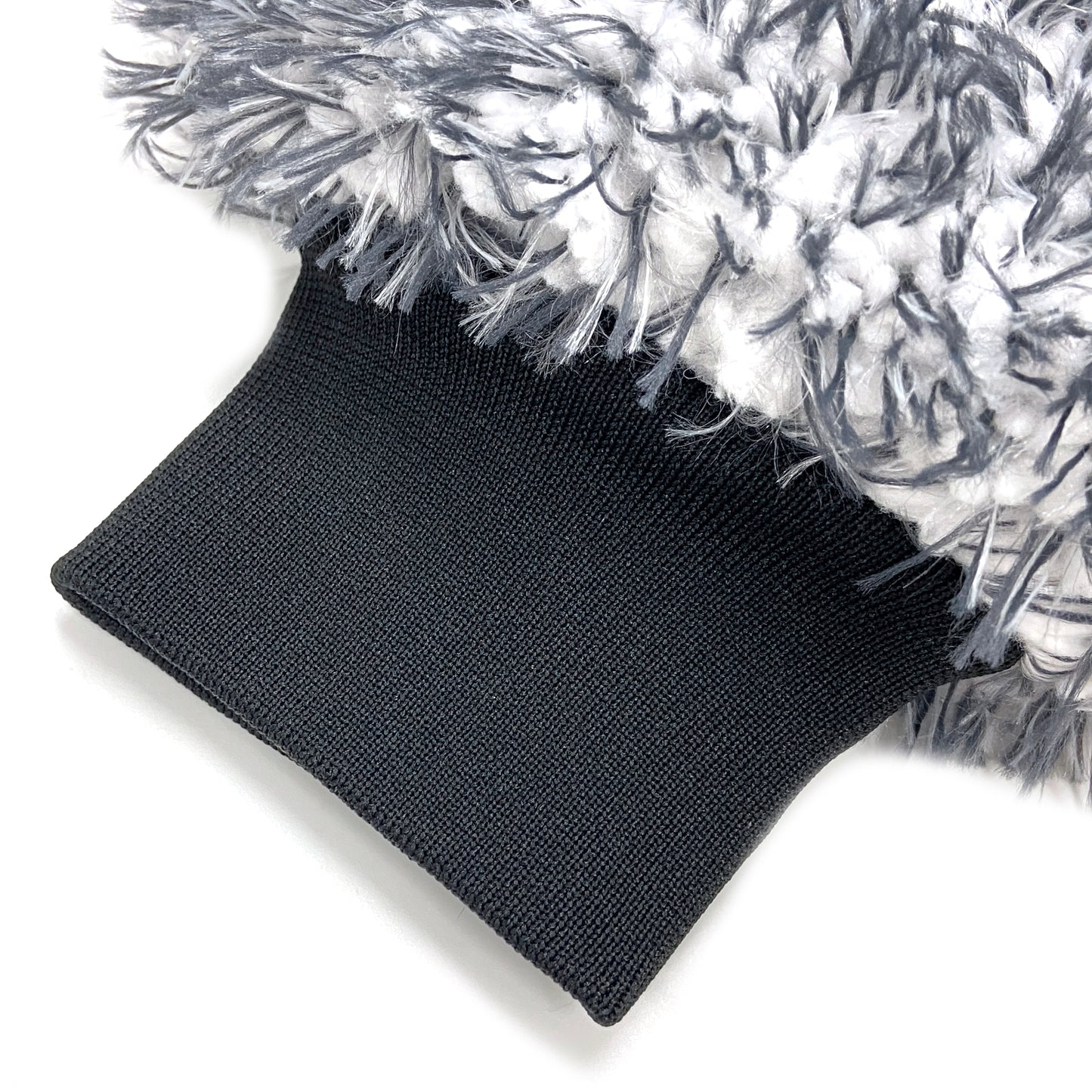 Close-up of the FibreKing Silver Label Korean Microfibre Wash Mitt - Black, showing its textured, fluffy gray and white microfiber and black ribbed cuff.