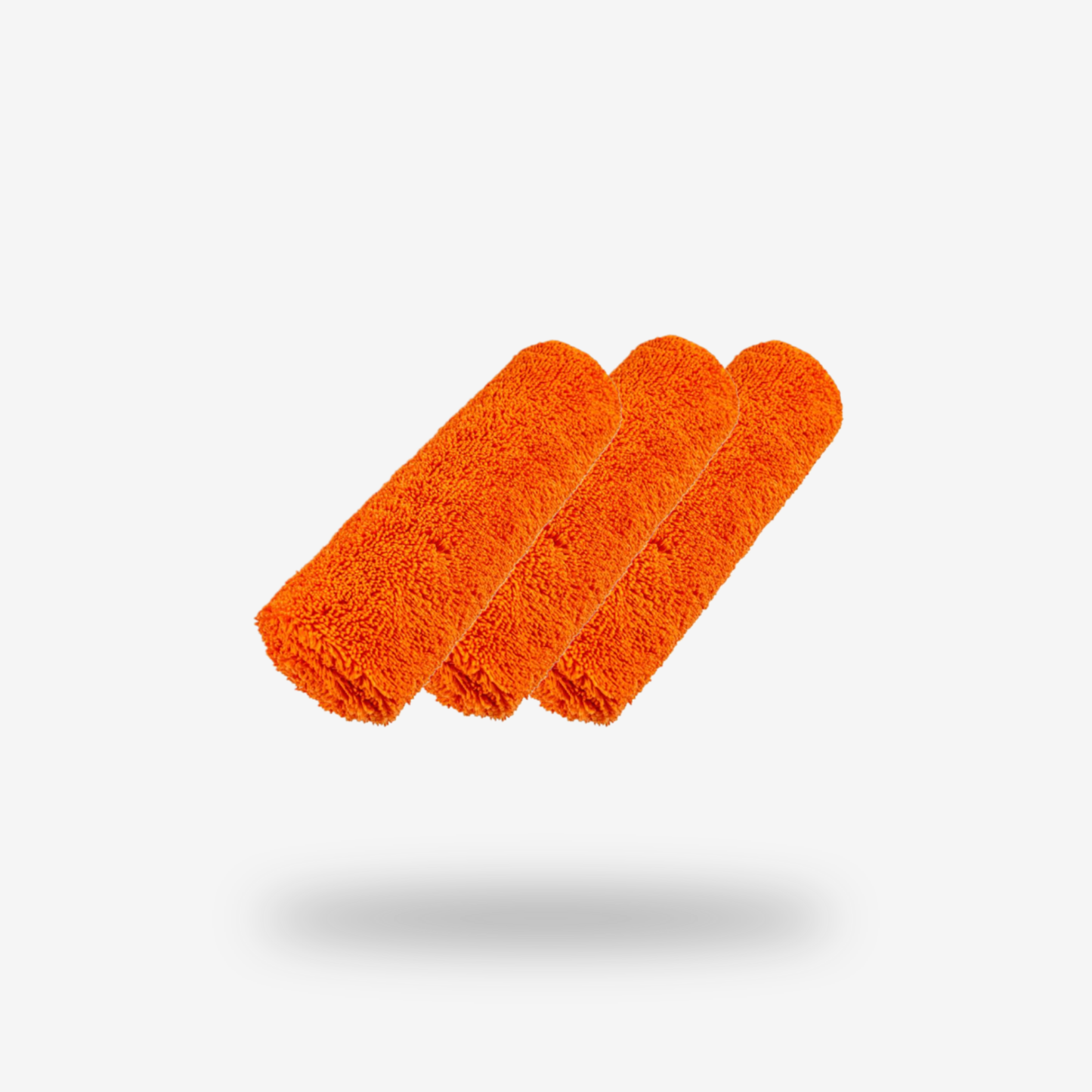 Three FibreKing Duplex edgeless cloths (orange, dual pile microfiber) are rolled and arranged in a row on a plain white background with a soft shadow beneath them. Sold as a 3 pack.