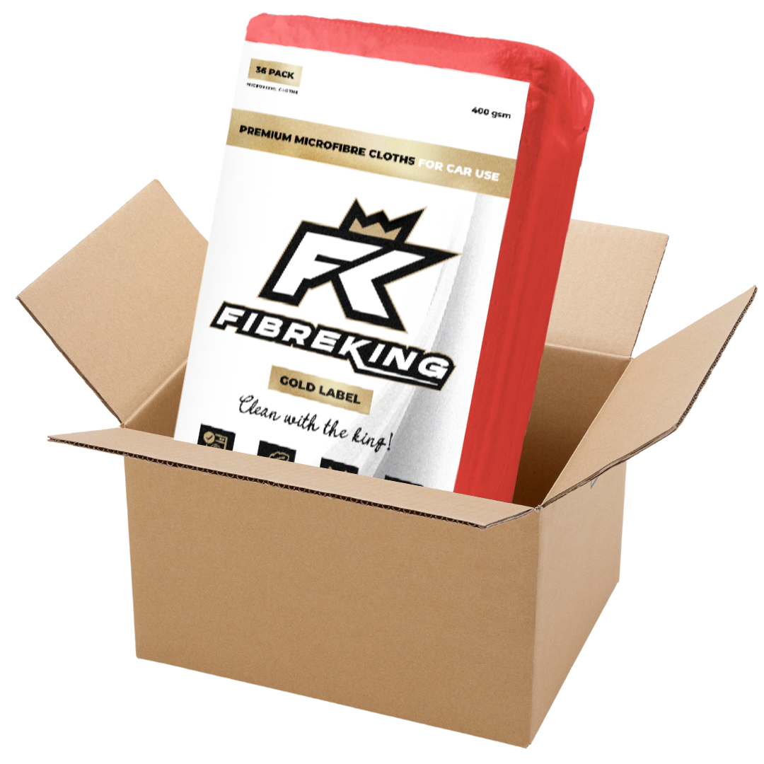 A FibreKing Gold Label 400GSM microfibre cloth box (6 packs of 36) for car use, partially removed from an open cardboard box.