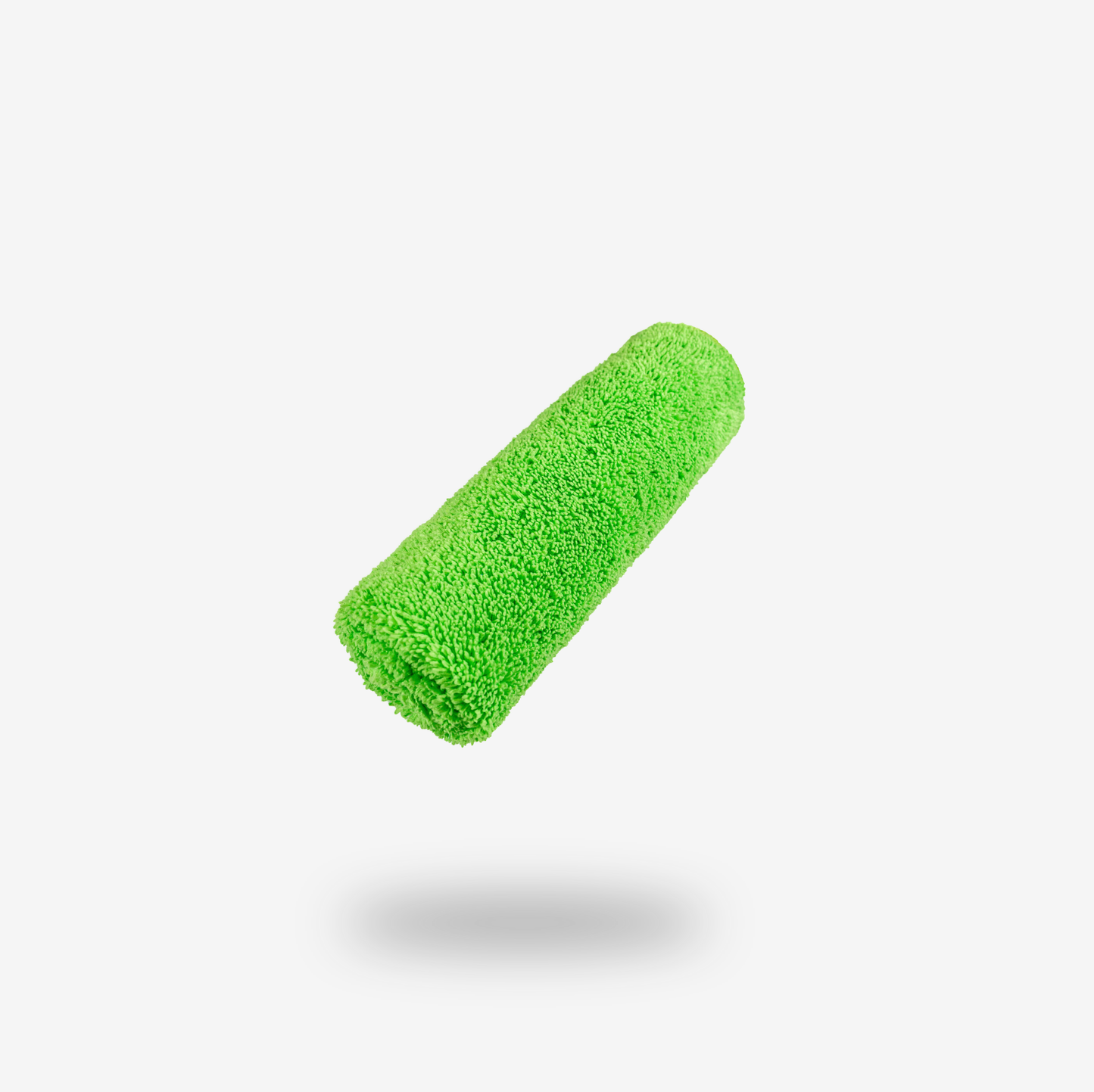 A green paint roller cover is centered on a white background with a faint shadow below it, next to FibreKing Silver Label Microfibre Box cleaning cloths for efficient cleanup.