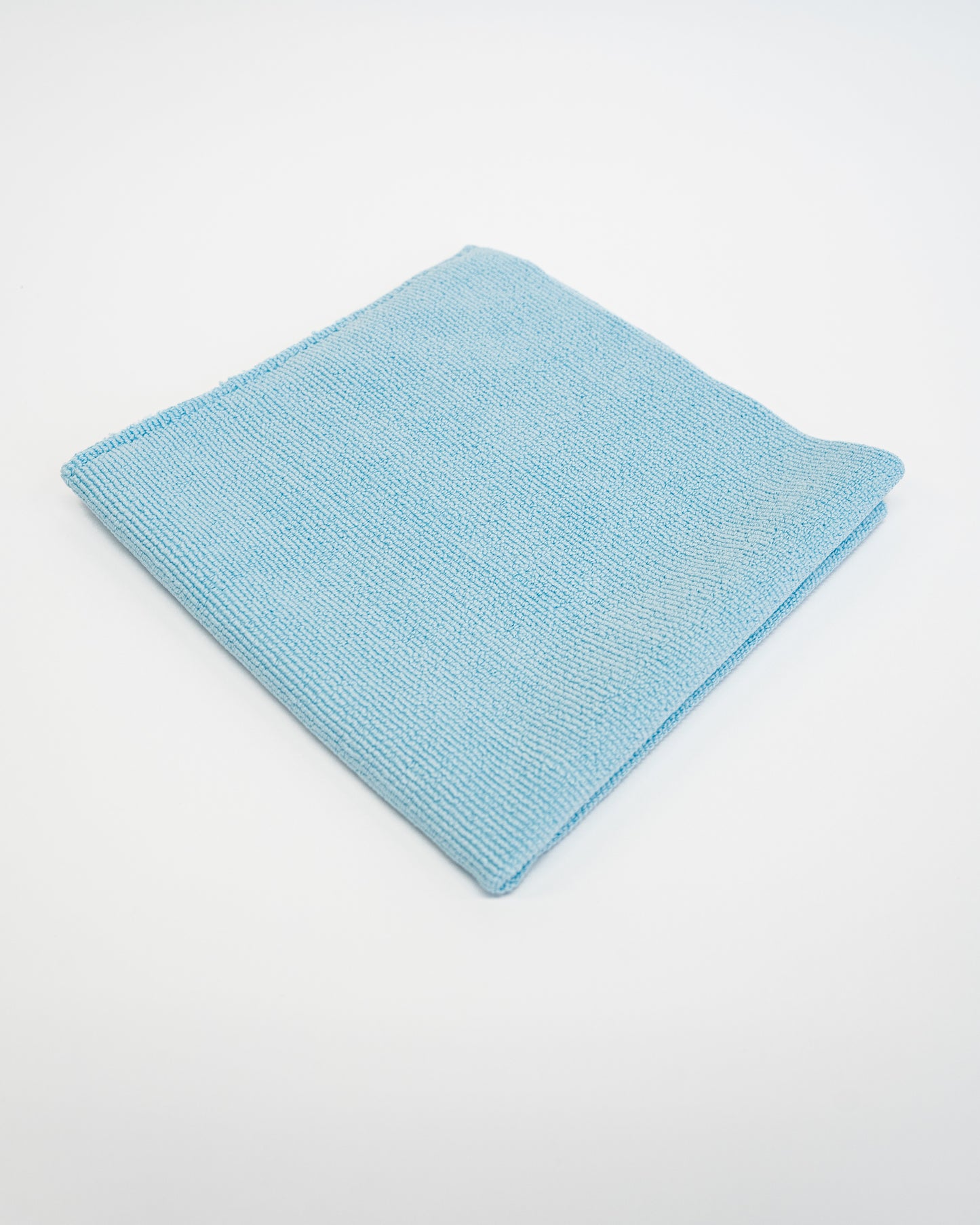 The FibreKing Soft Edgeless Multi-Purpose Microfibre Cloth, shown neatly folded in light blue on a plain white background, is ideal for all your detailing needs.