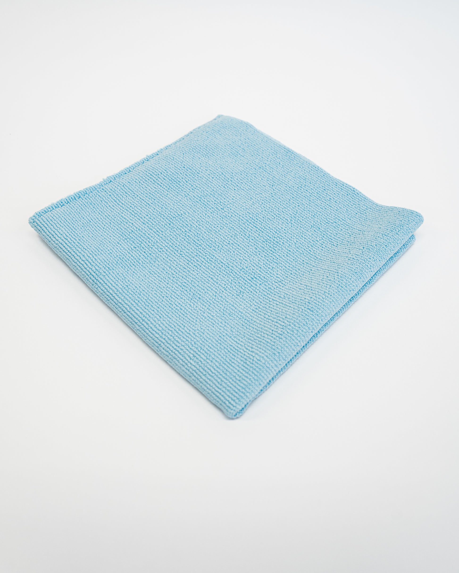 The FibreKing Soft Edgeless Multi-Purpose Microfibre Cloth, shown neatly folded in light blue on a plain white background, is ideal for all your detailing needs.