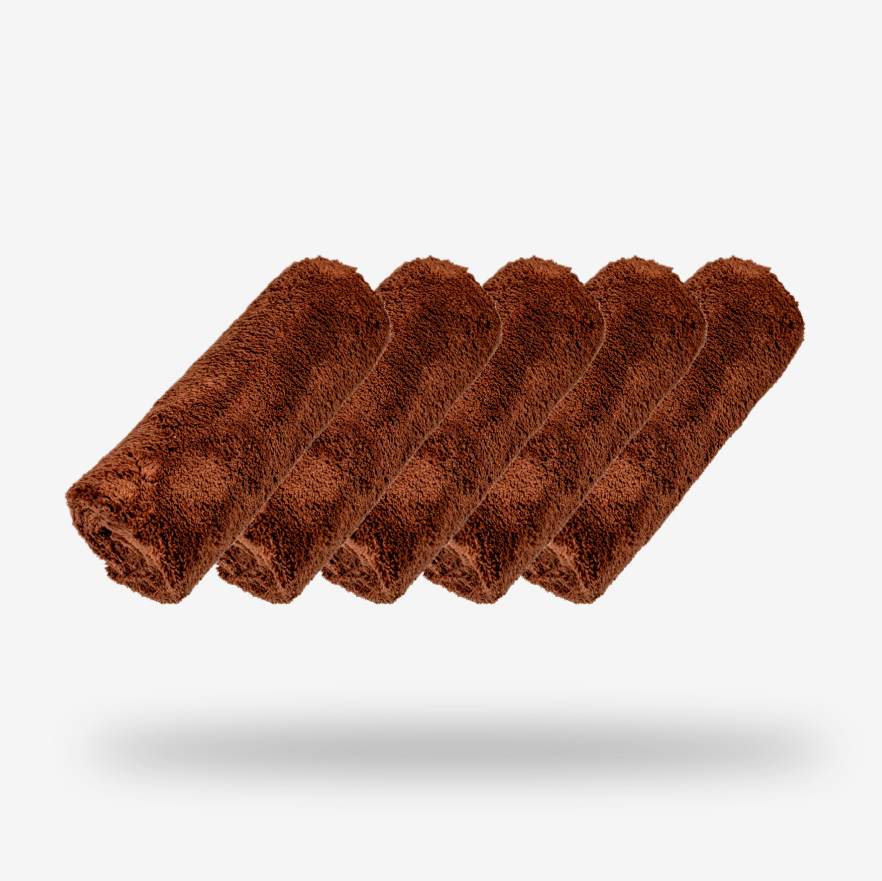 Five FibreKing Ultimate Detailer Cloths in brown are neatly rolled and lined up on a plain white background, with subtle shadows beneath them.