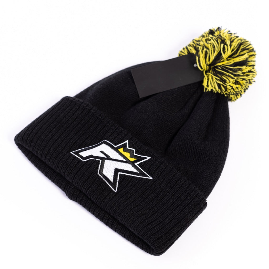 The FibreKing Beanie Hat by FibreKing is a black knit hat with a yellow and black pom pom, featuring an embroidered monogram and a yellow crown patch on the front.