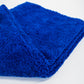 A close-up of a folded FibreKing Duplex edgeless cloth (3 pack) in bright blue dual pile microfiber, displayed on a plain white surface.