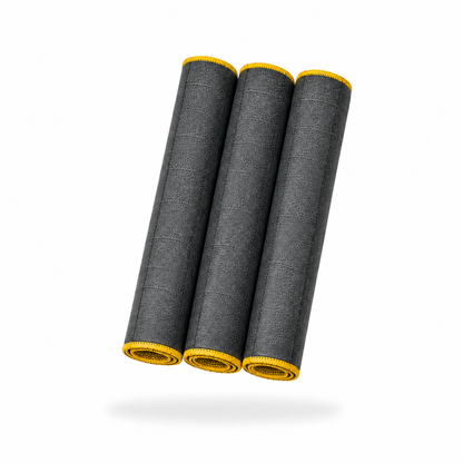 The FibreKing Carbon Glass Cloths - 3 Pack features three rolled carbon glass fibre mats with yellow edges arranged side by side on a white background.