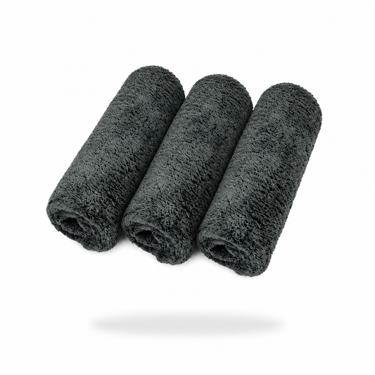 Three FibreKing Ultimate Detailer Cloths (3 pack - Grey) are rolled and arranged side by side on a white background, casting a soft shadow below.