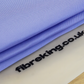 A folded Gold Label Korean Glass Cloth from FibreKing lies on a translucent mat with fibreking.co.uk printed in black, offering streak-free cleaning and high absorption. Pack contains 3 premium microfibre cloths.
