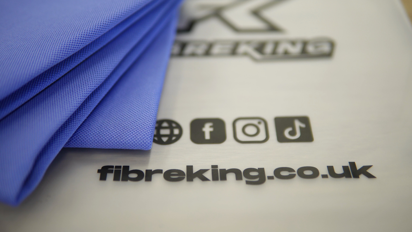 Close-up of folded FibreKing Gold Label Korean Glass Cloths (3 Pack), valued for high absorption and streak-free cleaning, next to a sheet displaying fibreking.co.uk and social media icons for Facebook, Instagram, and TikTok.