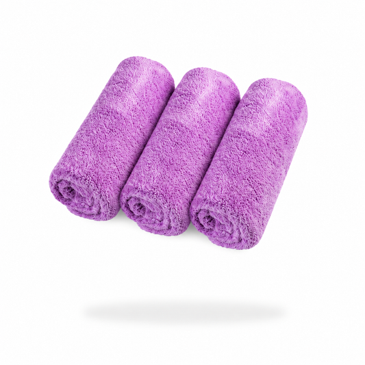 Three rolled, fluffy microfibre cloths from the FibreKing Ultimate Detailer Cloth 3 Pack are arranged side by side on a white background.