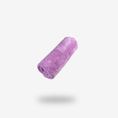 A rolled-up FibreKing Ultimate detailer cloth in purple coral fleece microfiber is centered on a white background with a faint shadow beneath it.
