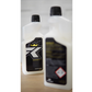 Two white FibreKing Microfibre Wash bottles with black caps—one focused showing the stylized R logo and crown, the other blurred with hazard symbols—ideal for caring for microfibre towels or as a detailing towel cleaner.