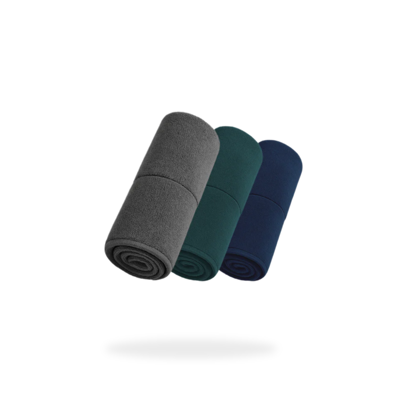 Three FibreKing Gold Label 900 GSM Korean Drying Towels in gray, green, and navy are rolled side by side on a white background, highlighting the premium quality of this 3-pack microfibre drying towel set.