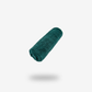A rolled-up turquoise FibreKing Build Your Own Gold label Pack cleaning cloth floats against a plain white background with a soft shadow below.