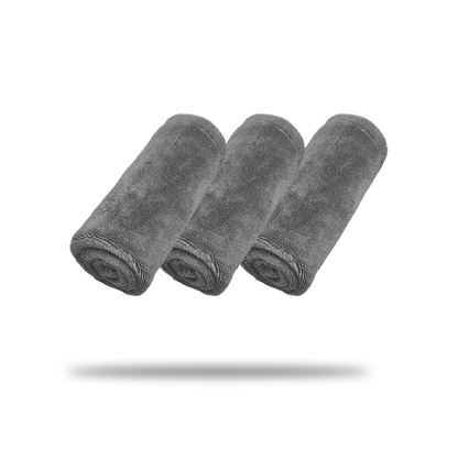 Three gray FibreKing Silver Label Drying Towels (3 Pack) are rolled and arranged side by side on a white background, with subtle shadows underneath.
