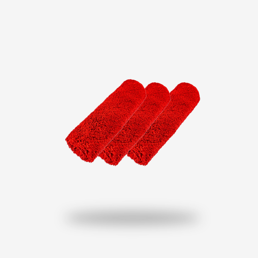 Three red FibreKing Duplex edgeless cloths (3 pack), made from dual pile microfiber, are rolled and arranged side by side on a plain white background with a shadow beneath.